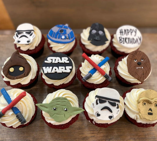 Star Wars-themed cupcakes on a wooden surface