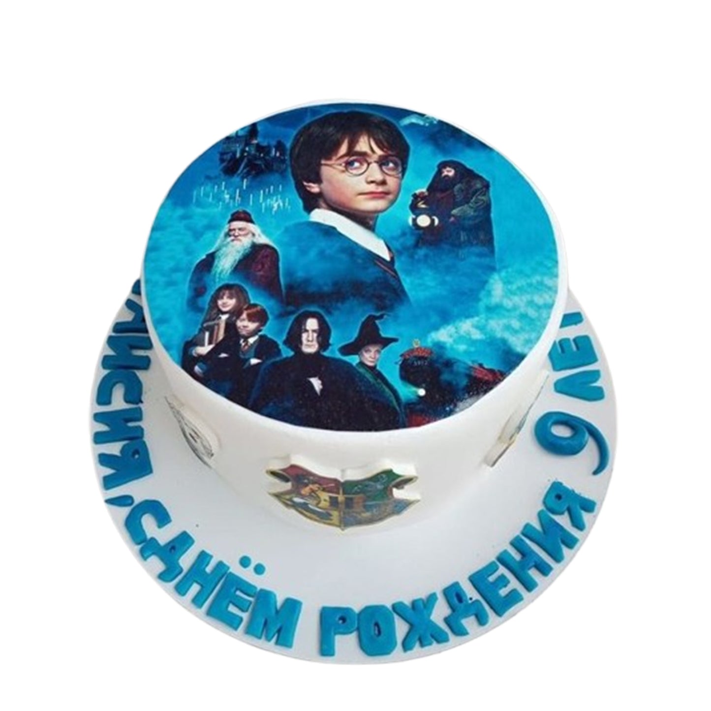 Multi-tiered Harry Potter cake with fondant Hogwarts castle towers and turrets, featuring a picture of Harry Potter