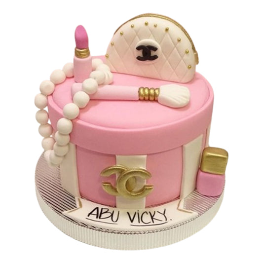 Makeup-themed cake featuring fondant makeup brushes arranged around the cake or as a topper, resembling a beauty artist’s workspace