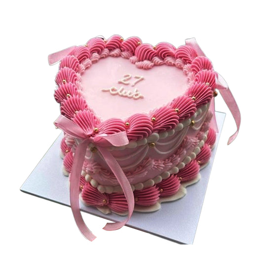 Delicious heart-shaped cake with creamy frosting