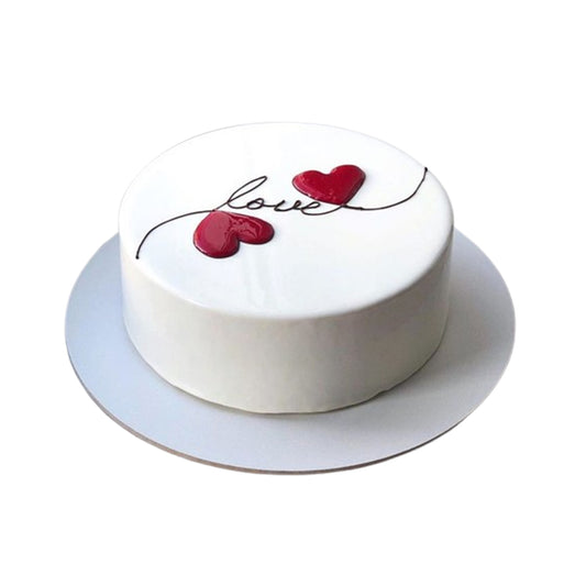 Decadent heart-shaped cake with chocolate ganache drips, shavings, and curls for a rich, indulgent dessert