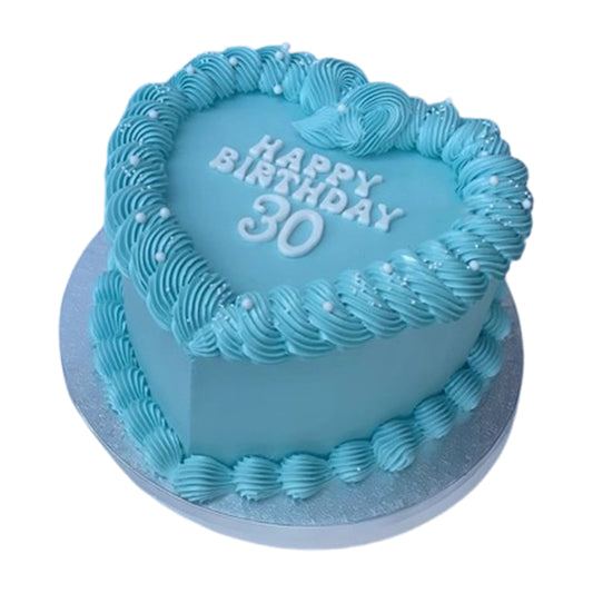 Freshly baked heart-shaped cake with a smooth fondant finish, offering a sleek and elegant design, available with free delivery
