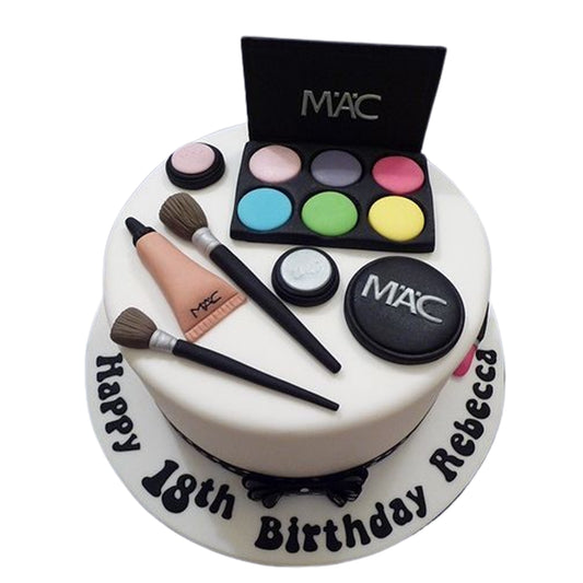 Custom beauty-themed cake with elegant fondant lettering and realistic makeup decorations for a special celebration.