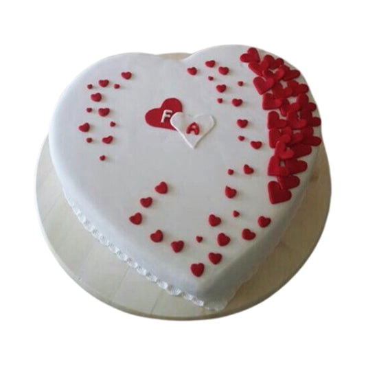Heart-shaped cake with creamy frosting and decorative toppings