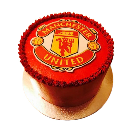 Glossy red Manchester United-themed cake with polished fondant and crisp white accents, embodying club pride.

