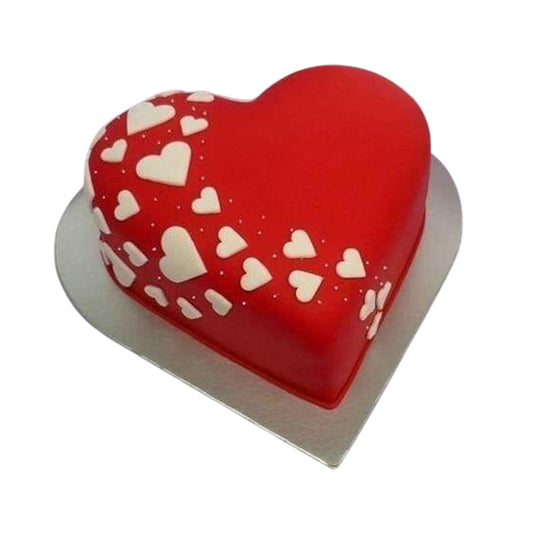 Heart-shaped cake covered in smooth, velvety frosting like buttercream, fondant, whipped cream, or rich ganache for a luxurious finish