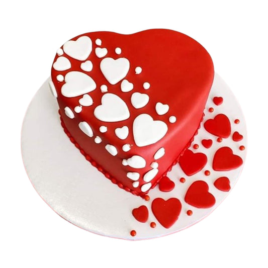 Heart-shaped cake with frosting in romantic shades of red, pink, or white, decorated with delicate rosettes, swirls, and intricate floral patterns.