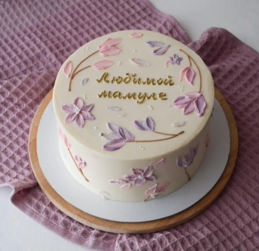 Floral buttercream celebration cake with pink flower decorations and personalised message