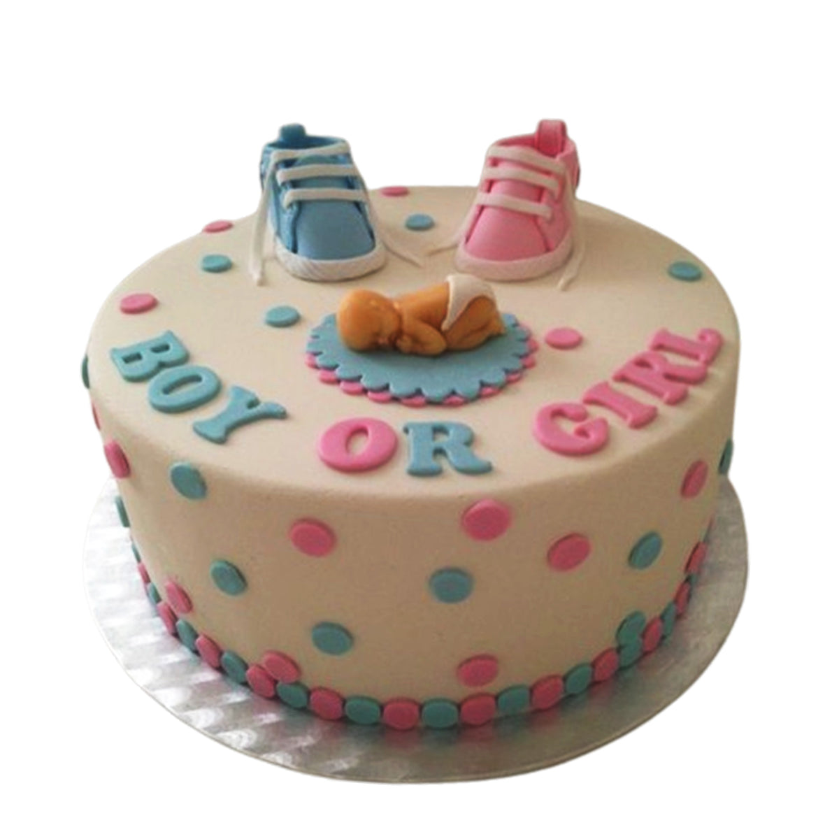 Cream Boy or Girl baby shower cake with pink and blue spots and two baby shoes on top